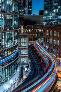 A time-lapse photo showing train lines moving through a city