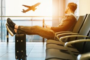 Man in airport watches plane take off