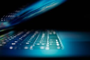 Laptop showing keys and blue light